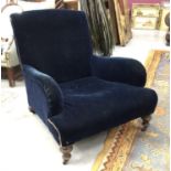 Late 19th / early 20th century oak upholstered deep armchair in the manner of Howard & Sons