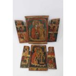 Two Greek Orthodox folk art folding triptych icons, the largest 31cm high