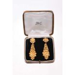 Fine pair of large Victorian gold pendant earrings, each with a stylised floral rosette suspended fr