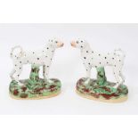 Pair of Staffordshire pottery models of Dalmatians, shown standing on naturalistic bases, 16cm high