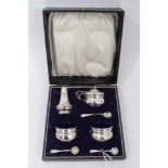 1920s silver four piece condiment set, comprising pair salts, mustard and pepper in a fitted case