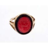 Victorian gold signet ring, the oval garnet/red coloured glass bezel with intaglio engraved family c