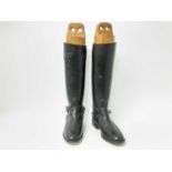 Pair of black leather hunting boots with trees