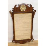 George II style mahogany fret carved wall mirror, the pierced carved top centred with a gilt floral