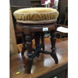 Edwardian carved walnut revolving piano stool with turned supports