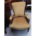 Victorian mahogany framed nursing chair with upholstered seat back and arms on turned front legs