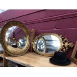 Three framed wall mirrors and a gentleman,s hat