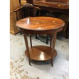 Edwardian inlaid mahogany oval two tier occasional table on splayed legs and brass castors