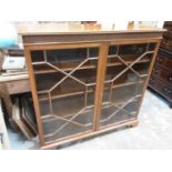 Good quality early 20th century mahogany bookcase with blind fret decoration and shelved interior en