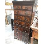 Reproduction mahogany chest on chest with two short and three long drawers above, brushing slide and