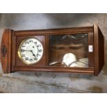 1930's wall clock with eight day striking movement, bevelled glazed oak case, pendulum and key