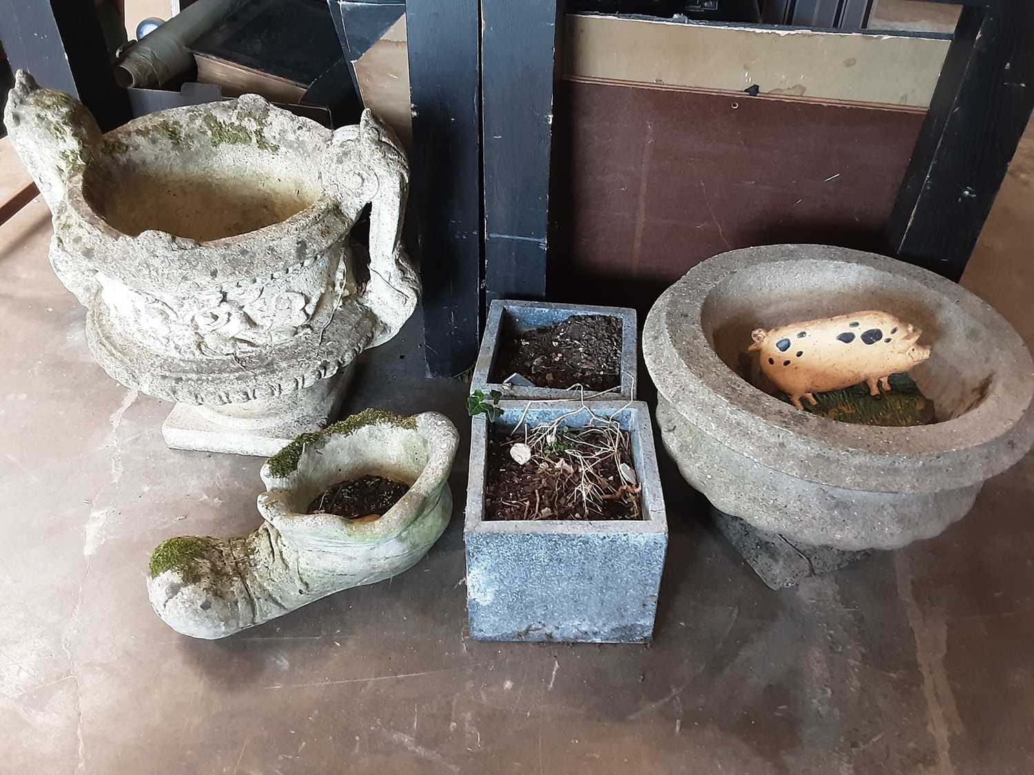 Two concrete garden pots plus three others