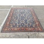 Eastern rug with geometric decoration on red, blue and cream ground, 251cm x 191.5cm