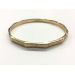 9ct gold faceted bangle with Greek key decoration