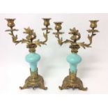 Pair of rococo ormolu and porcelain twin branch candelabra, with bulbous duck egg inverted baluster