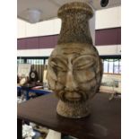 African carved greenstone vase with mask decoration on both sides, 40cm high