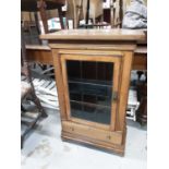 Edwardian cabinet with shelved interior enclosed by glazed door with drawer below