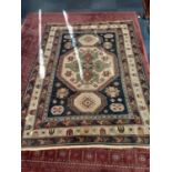 Eastern rug with geometric decoration on blue, red and cream ground, 204cm x 145cm