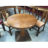 Art Deco oak circular centre table and six Art Deco oak dining chairs (7)