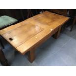 Heavy pine coffee table with sliding panels to top and storage below