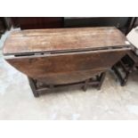 18th century ok oval drop flap table on turned supports joined by stretchers