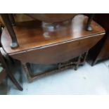Antique drop leaf table with a drawer to each end on bobbin turned and block legs joined by stretche