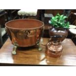 Large copper wine cooler with brass lion's mask handles and paw feet, together with a copper kettle