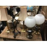 Two pairs of brass oil lamp style table lamps, two pairs of brass candlesticks table lamps and a got