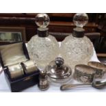 Pair silver collared glass perfume bottles, silver topped glass powder pot, two pairs silver napkin
