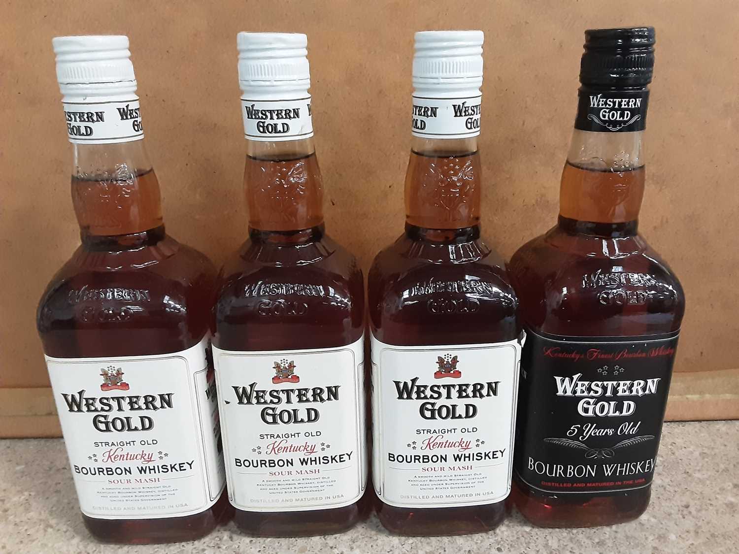 Three bottles of Western Gold Sour Mash Kentucky Bourbon whisky and another bottle of Western Gold 5