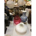 Chinese blue and white porcelain table lamp, together with a brass oil lamp, brass table lamp and cr