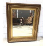 Large bevelled wall mirror in ornate gilt frame