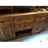 Late Victorian/Edwardian carved walnut sideboard with three drawers and four carved panelled doors b