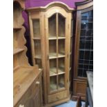 Pine display cabinet with arched glazed door and four shelves and drawer below on bunn feet 188 cm h