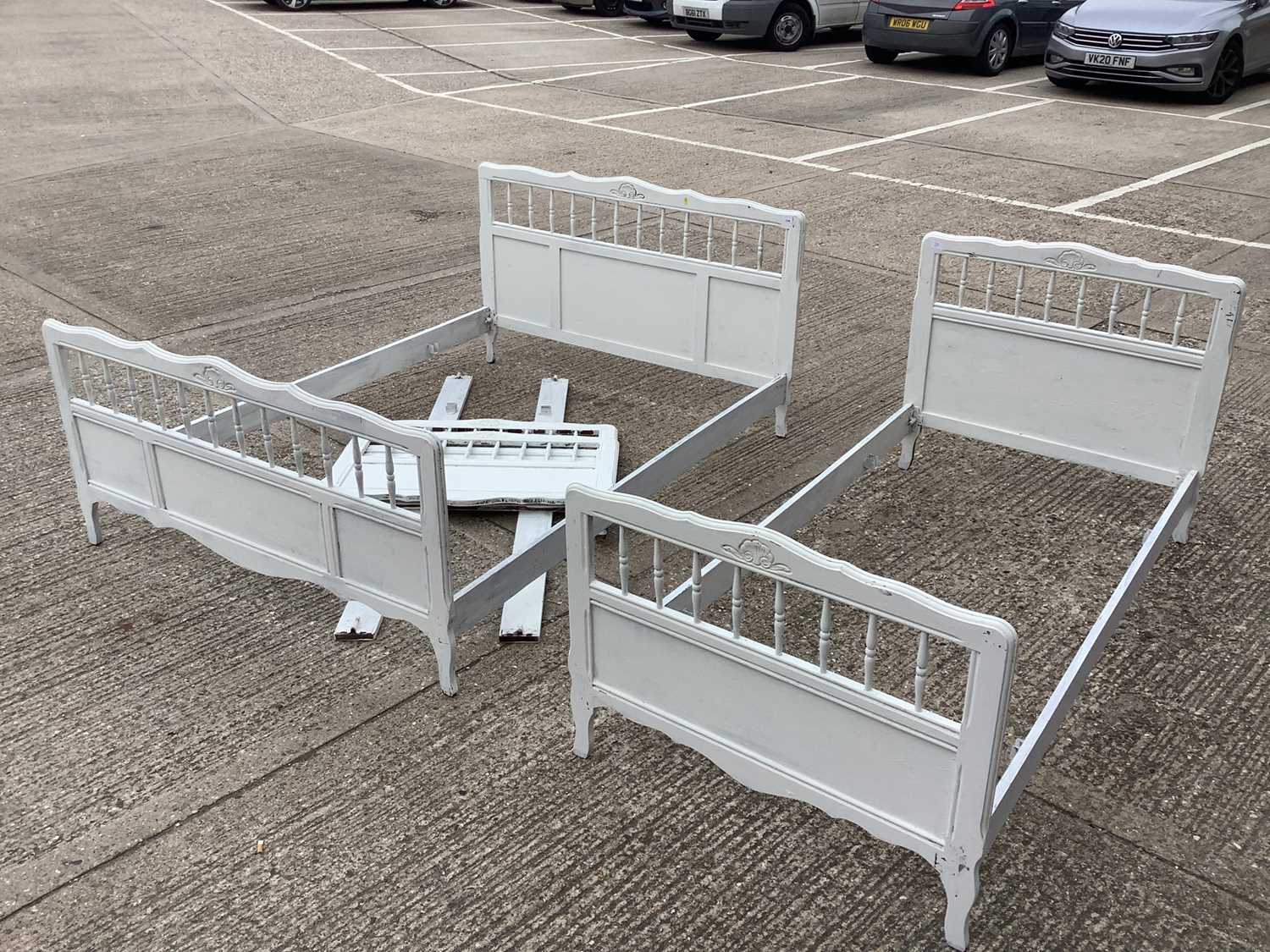 White painted double bed with spindle decoration, and a pair of matching single beds