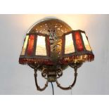 Pair of brass twin branch wall lights, each with domed panel, formed from warming pan covers