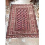 Eastern rug with geometric decoration on red and blue ground, 183cm x 127cm