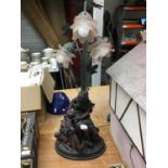 Spelter figural lamp with three frosted pink glass shades