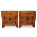 Pair of Chinese elm bedside tables with single drawer and cupboard below with brass handles, 63cm wi