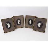 Set of four Wedgwood 'basalt' jasperware plaques, of oval shape, decorated in the classical style wi