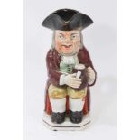 Staffordshire pearlware-glazed Toby jug, circa 1820, typically modelled and polychrome painted, 25cm