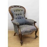 Victorian carved walnut open armchair, with button upholstered spoon back and seat within pierced ca