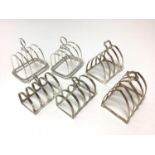 Three pairs of silver toast racks (Various dates and makers). All at approximately 12ozs. L