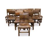 Set of twelve Cromwellian style oak and brown leather dining chairs with padded backs and seats and
