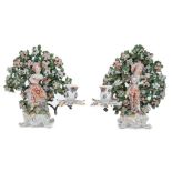 Pair of Bow 'New Dancer' figure candlesticks, circa 1765, with bocage decoration behind each figure,