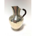 Victorian silver jug of baluster form, with double hinged cover and leather covered handle