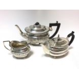 1920s silver teapot of half fluted form, with matching cream jug ( London 1920) Maker's mark rubbed