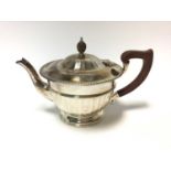 1930s silver tea pot of half faceted form, with flared border and hinged domed cover