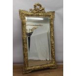 Neoclassical style gilt wall mirror, rectangular bevelled plate with trophy cresting and scrolled ki