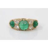 Victorian style emerald and diamond ring with three cabochon emeralds and four old cut diamonds with